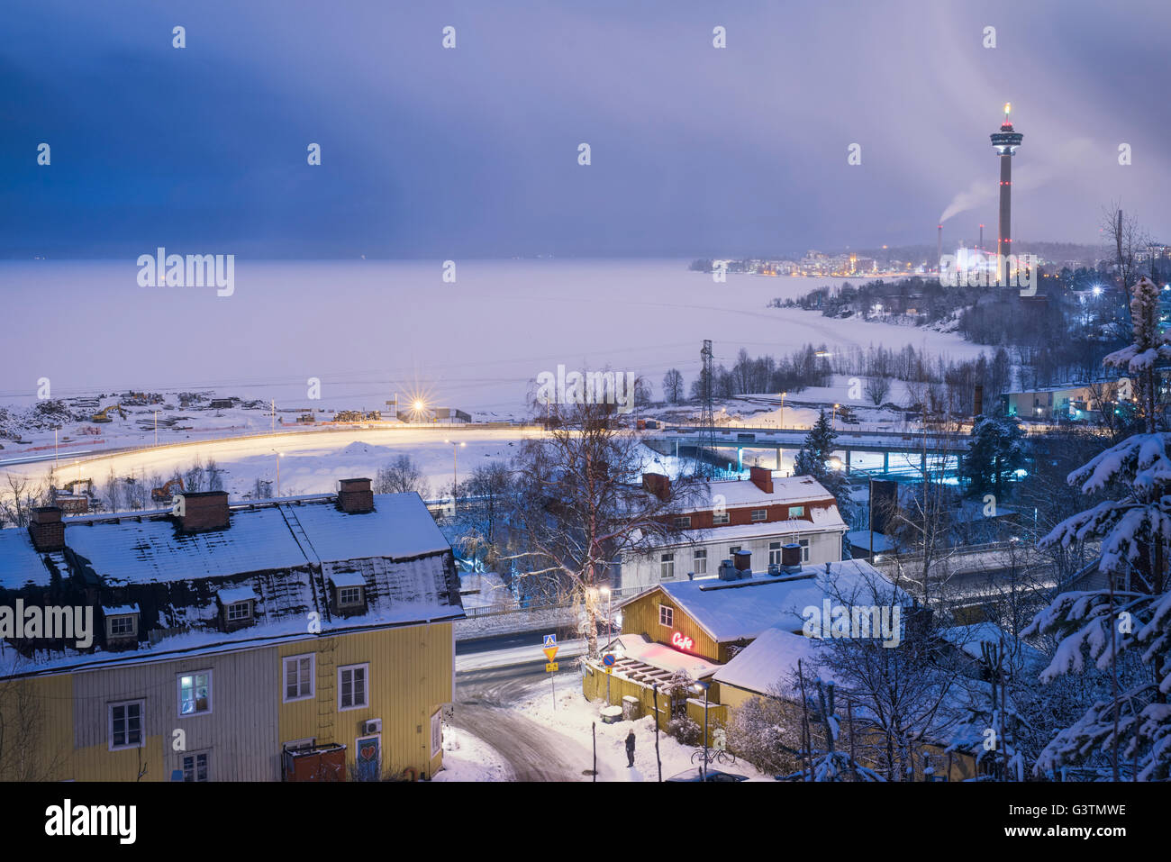 Finland, Pirkanmaa, Tampere, Nasijarvi, Illuminated cityscape with frozen lake in background Stock Photo