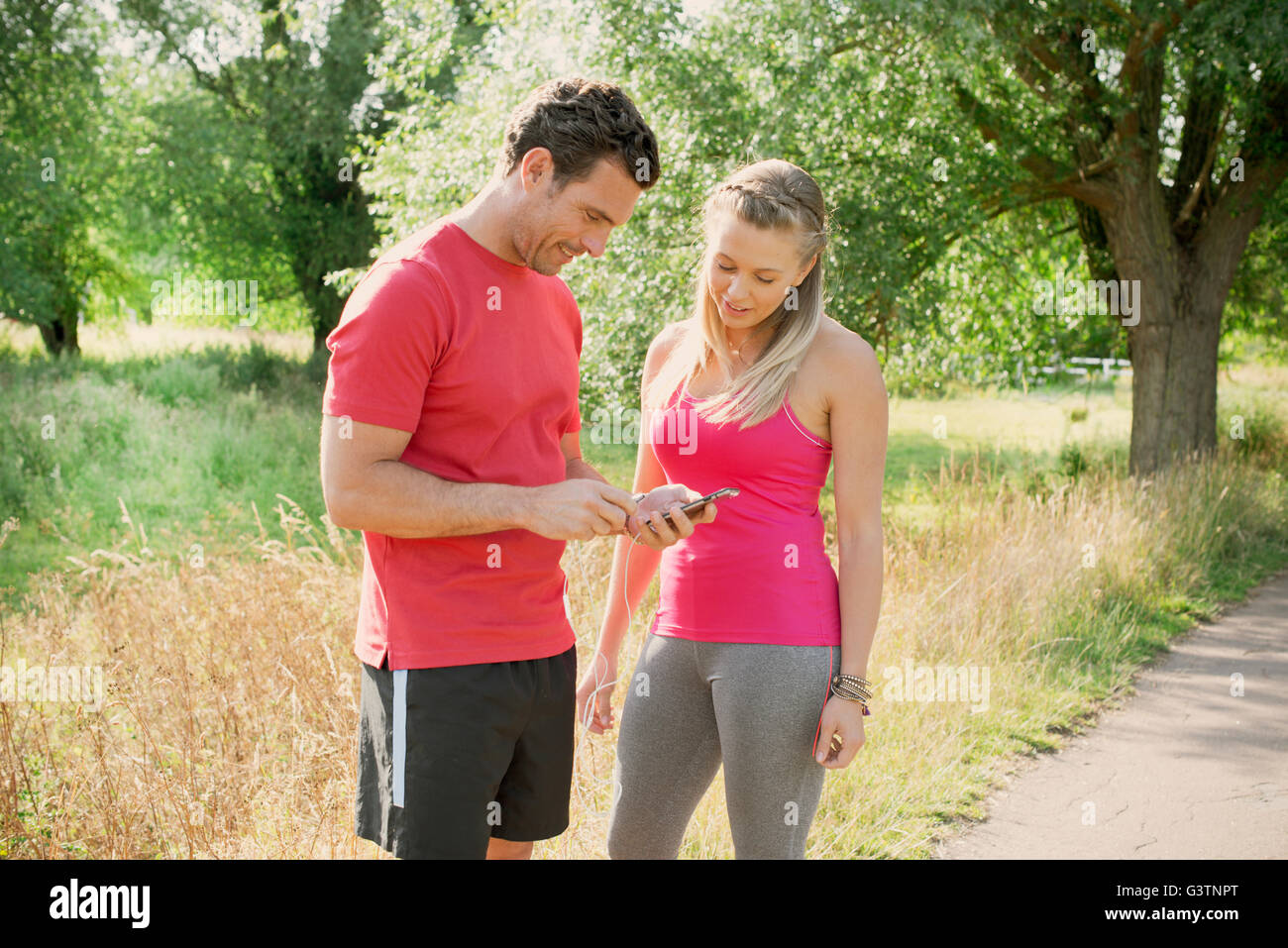Two joggers chatting in a park Stock Photo