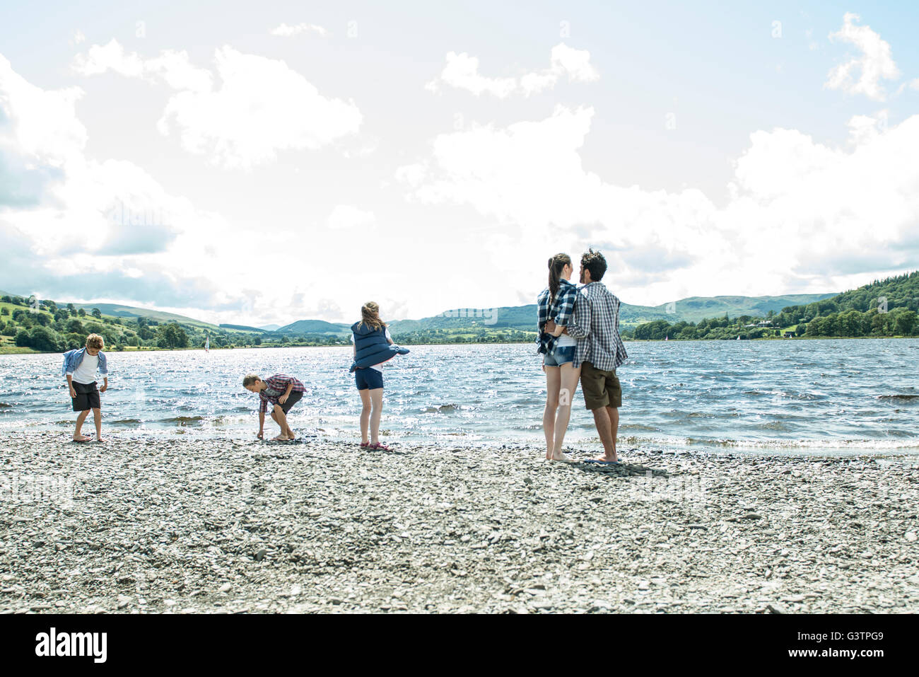 A family of five standing on the shore beside Bala Lake in Wales. Stock Photo