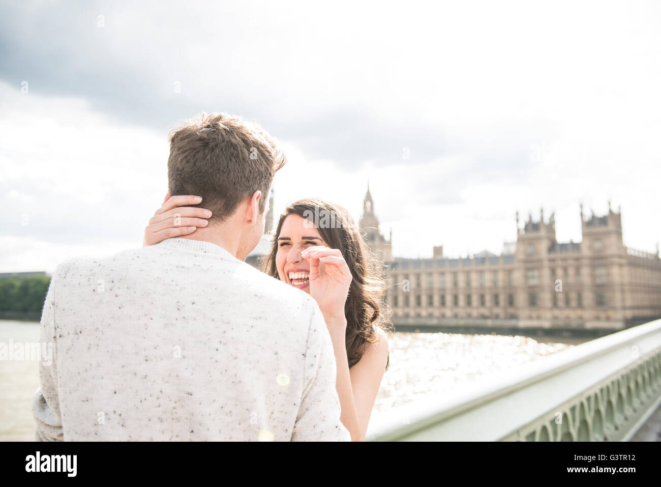 A young couple cuddling on Westminster Bridge in London. Stock Photo