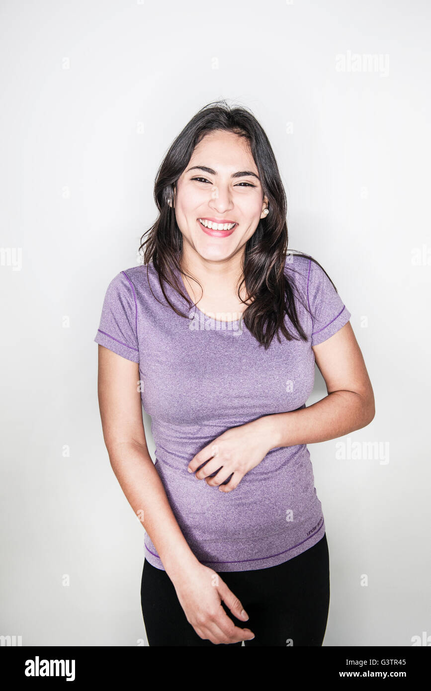 A young middle eastern woman posing in a studio looking happy. Stock Photo