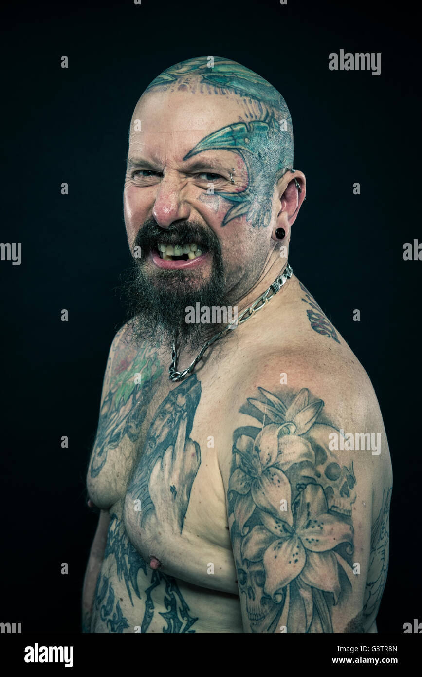 Studio portrait of a heavily tattooed older man. Stock Photo