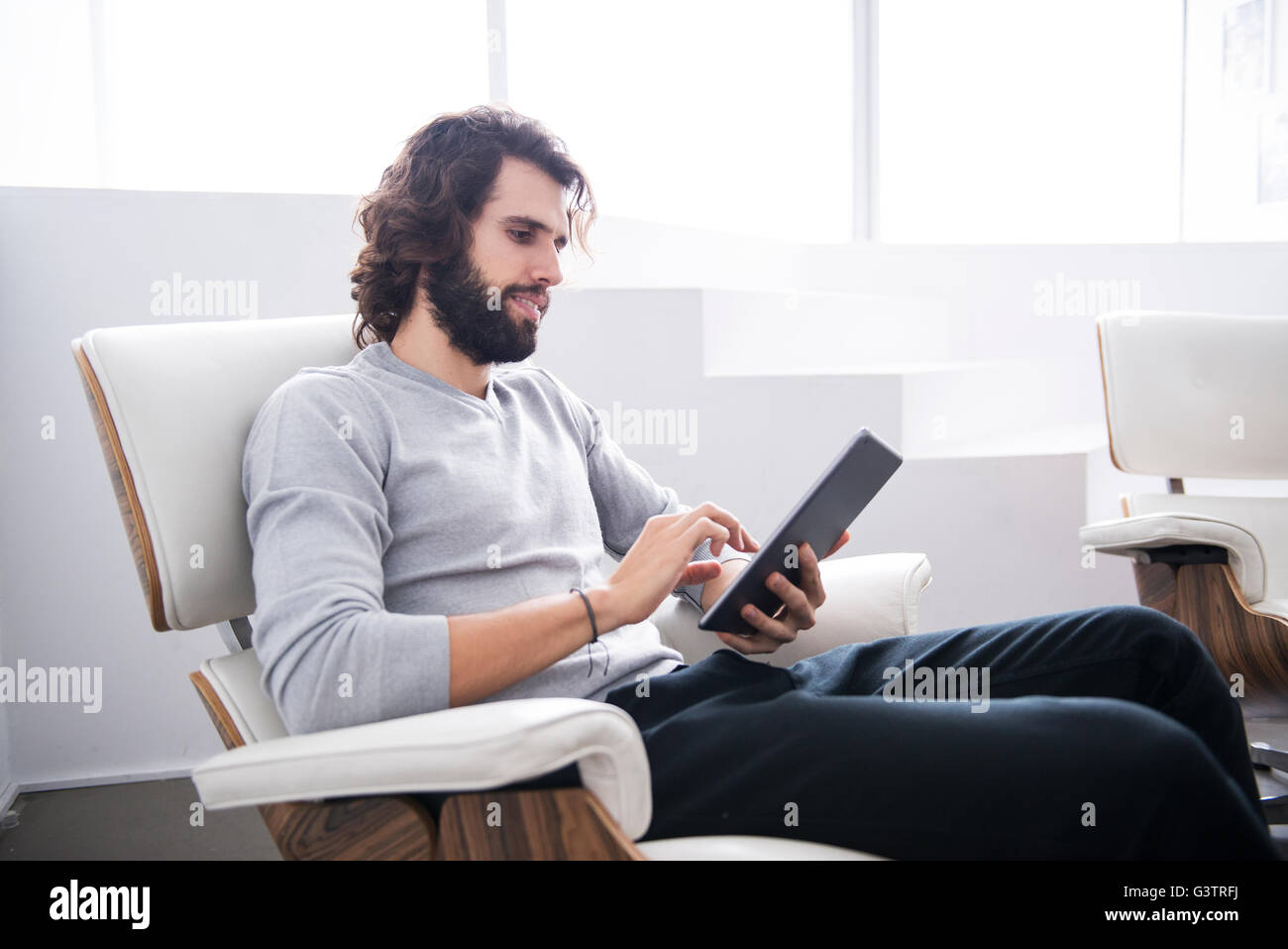 A Professional Man Looking At A Tablet Computer In An Office Stock