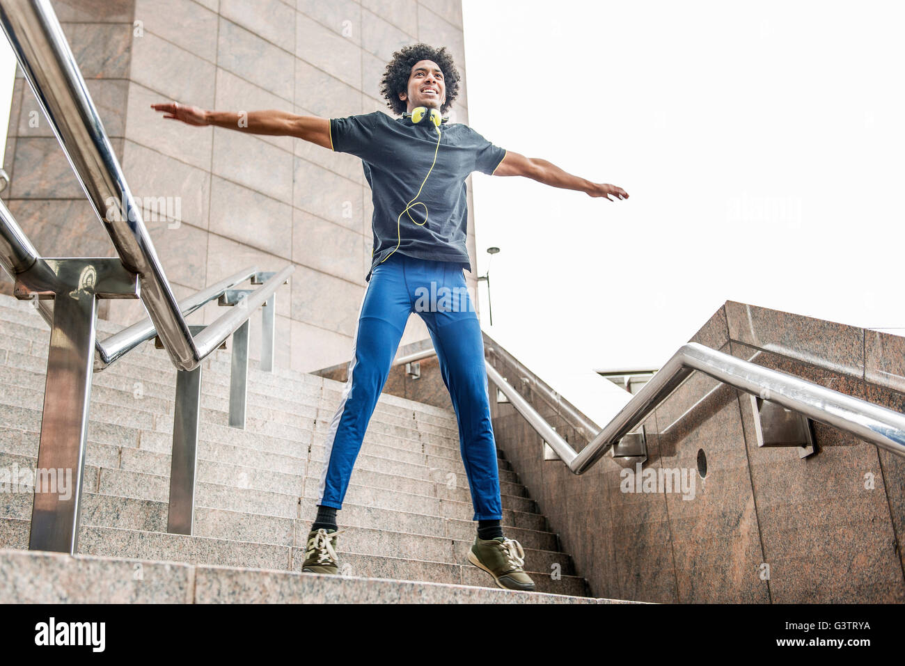 A young man limbering up for a jog along the South Bank in London. Stock Photo