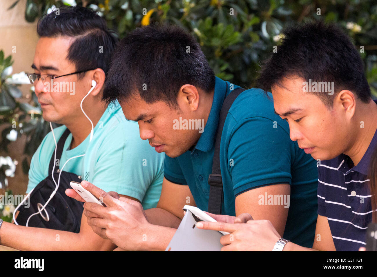 Tourists checking mobile phones Malta Stock Photo Alamy
