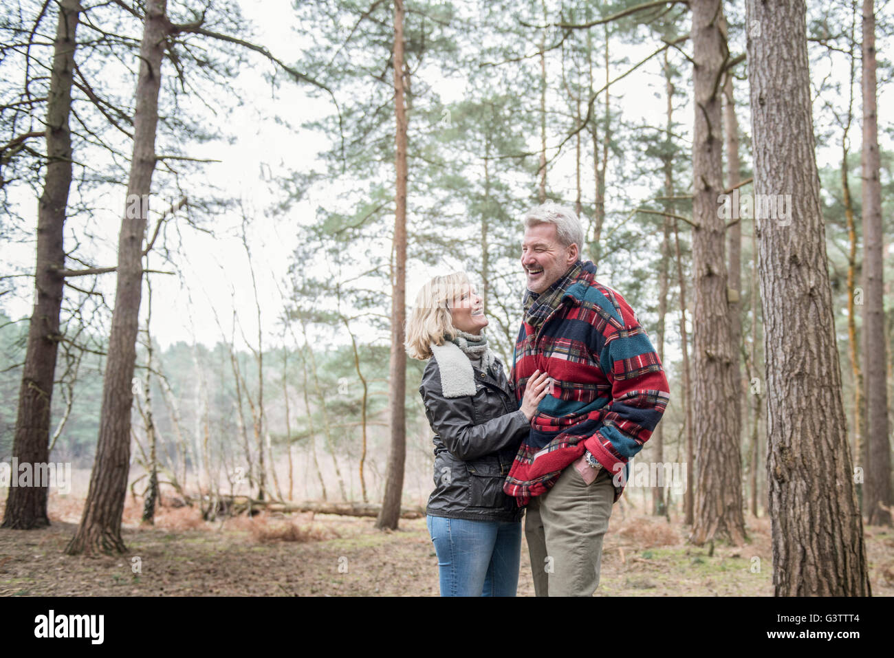 Senior couple enjoying a walk in the woods Stock Photo - Alamy