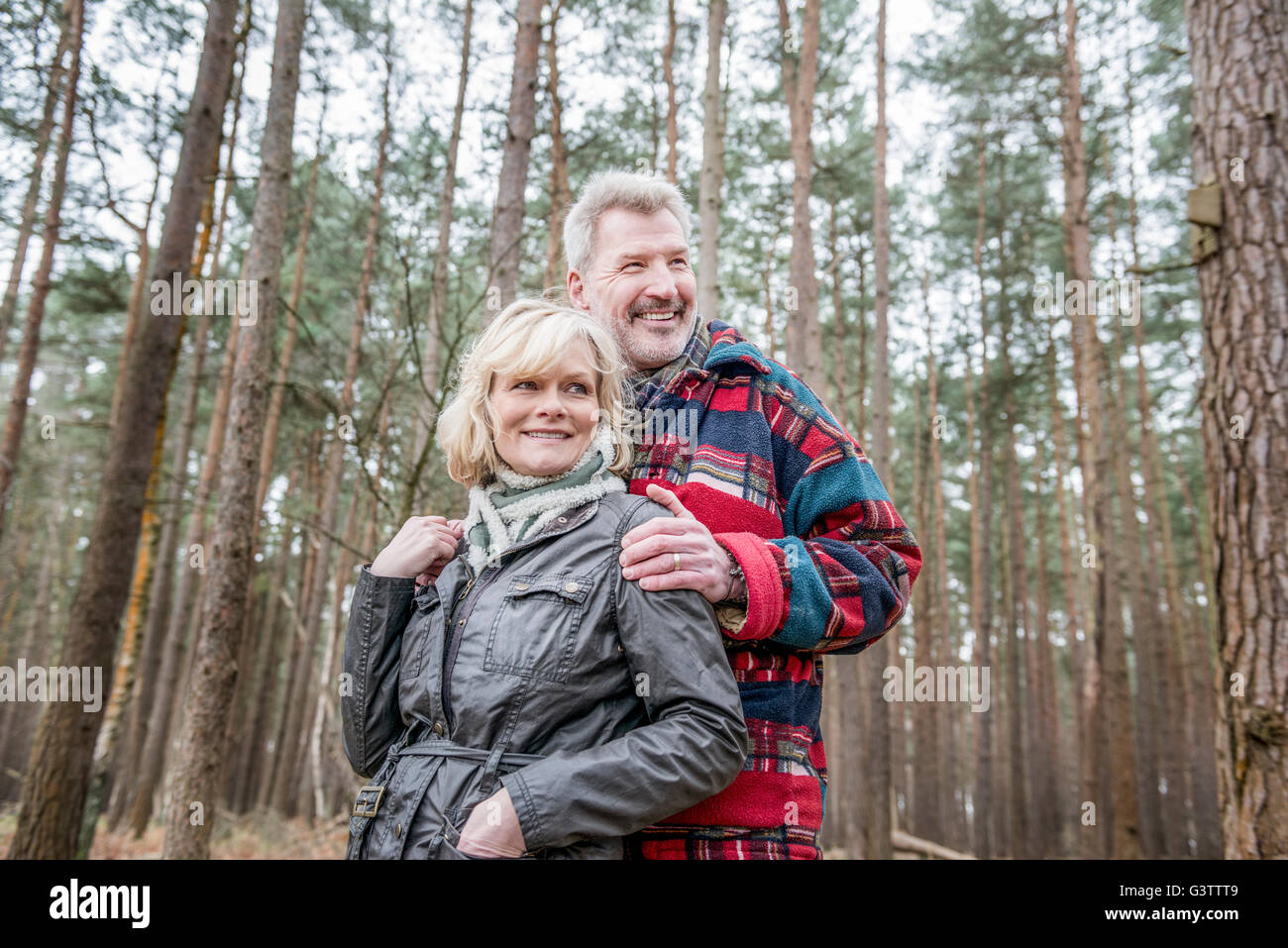 Senior couple enjoying a walk in the woods Stock Photo - Alamy