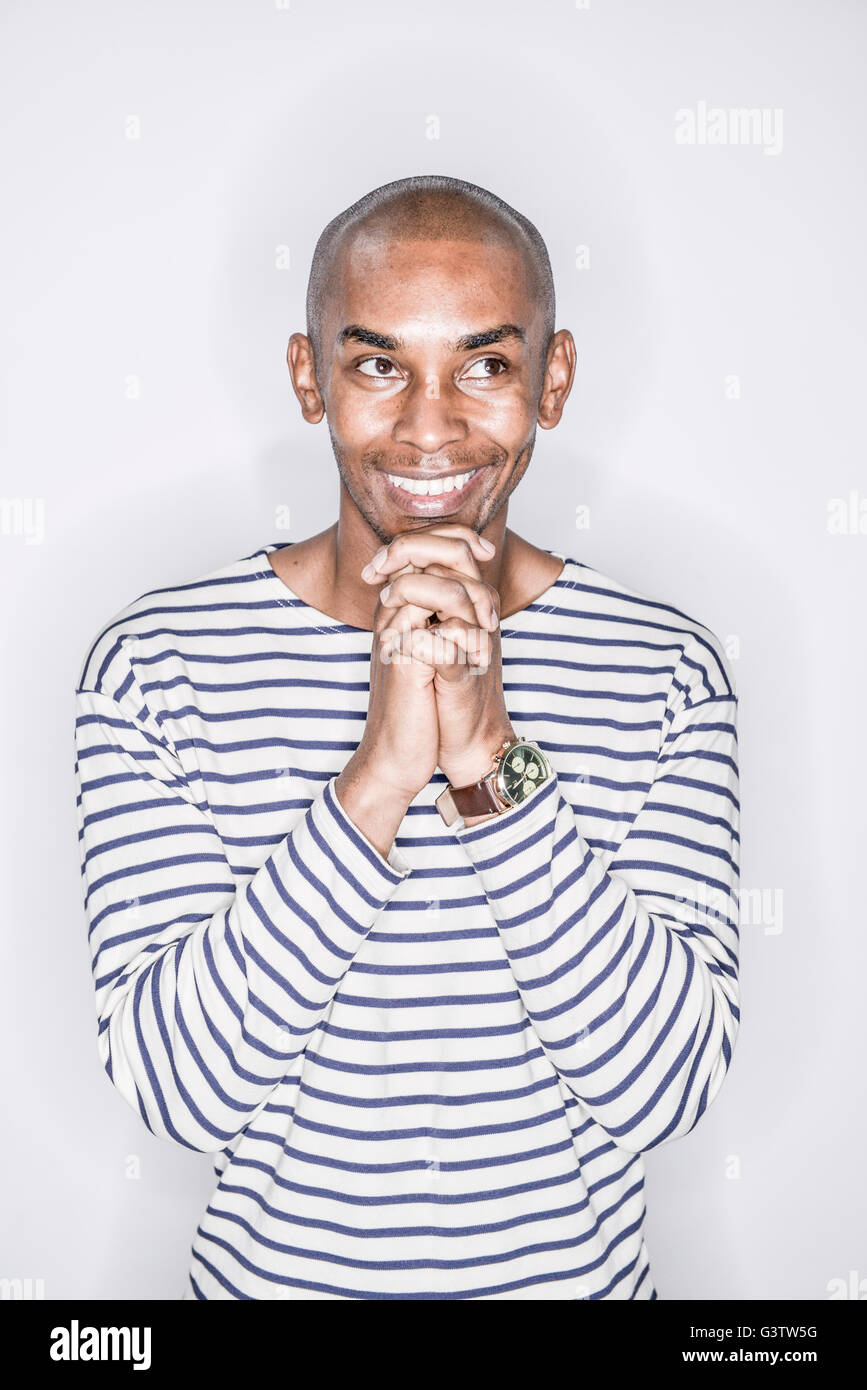 A young african man posing in a studio looking happy Stock Photo Alamy