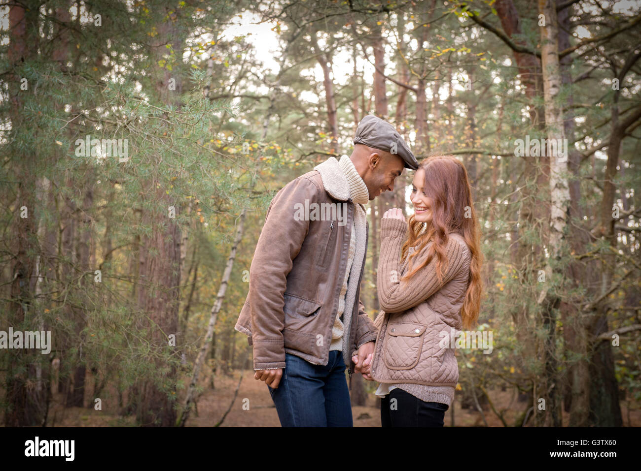 A young couple enjoying a forest walk in Autumn. Stock Photo