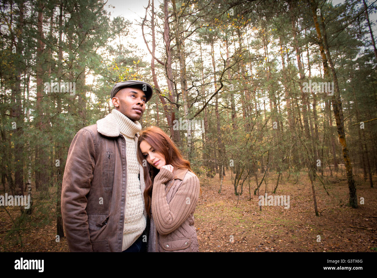 A young couple enjoying a forest walk in Autumn Stock Photo - Alamy
