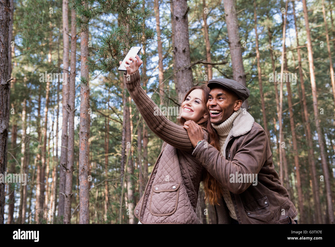 A young couple taking a selfie on a forest walk in Autumn Stock Photo ...