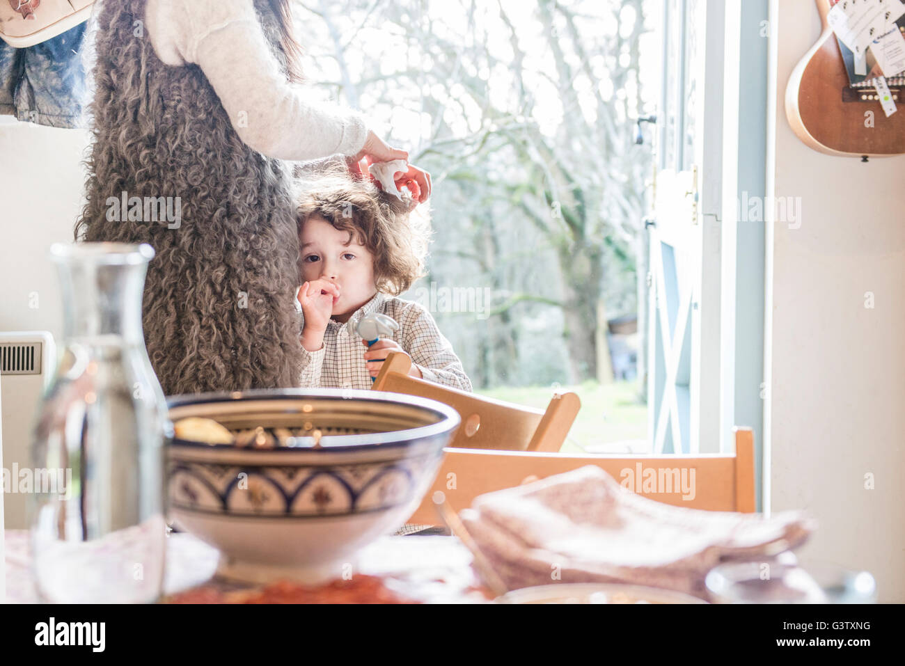 mum boy sucking A four year old boy standing in a kitchen next to his mother sucking his  thumb Stock Photo - Alamy