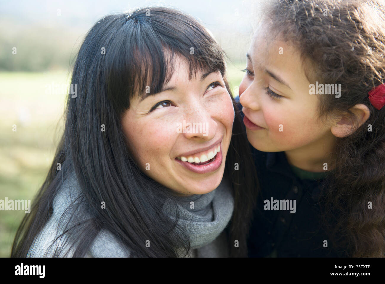 A mother and six year old daughter enjoying being out in the garden on an early Spring day. Stock Photo