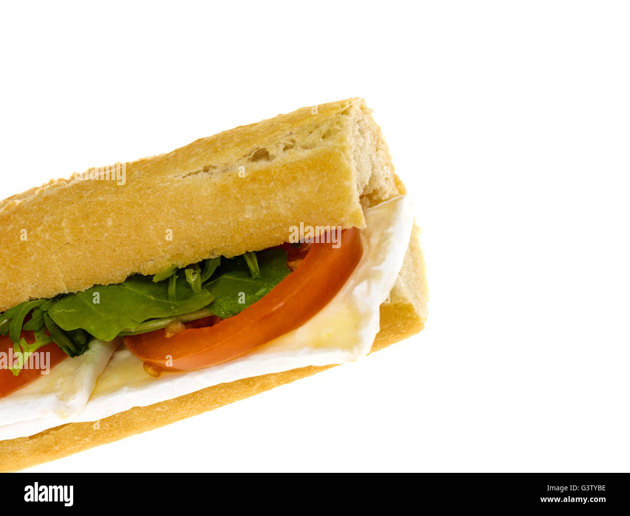 Fresh Cut Healthy Eating Brie Cheese and Tomato Baguette Bread Roll Isolated Against A White Background With Copy Space Stock Photo