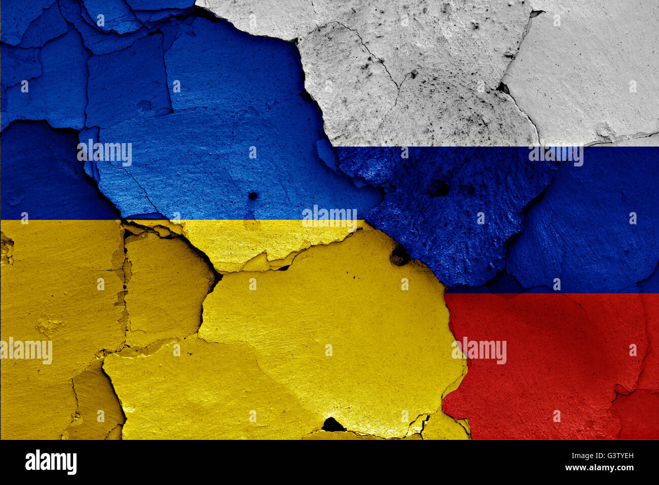 flags of Ukraine and Russia painted on cracked wall Stock Photo