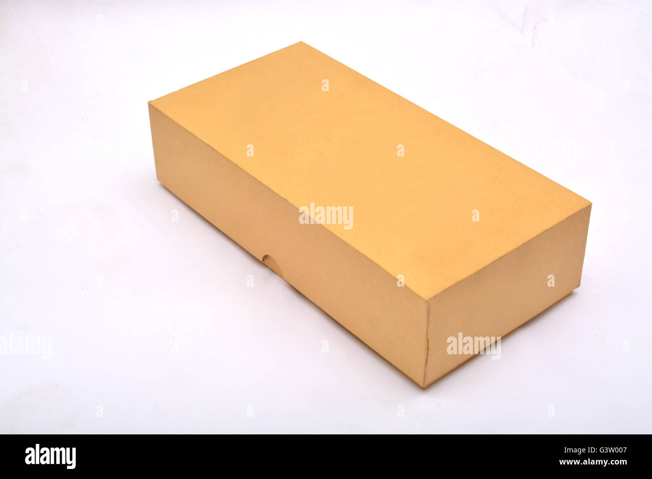 Closed cardboard box isolated on a white background. Stock Photo