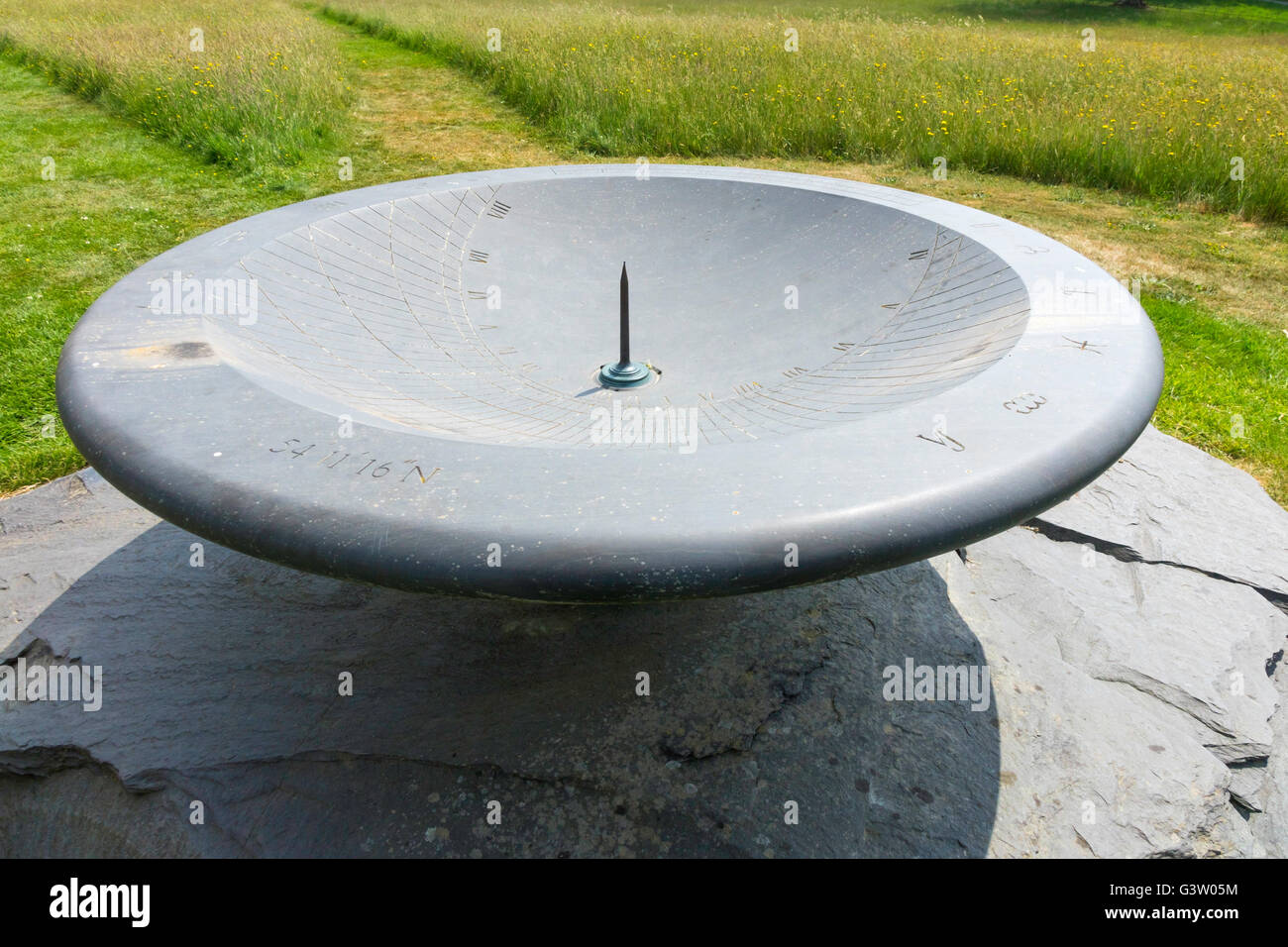 The large bowl shaped slate sundial at Holker Hall Cark in Cartmel Cumbria UK Stock Photo