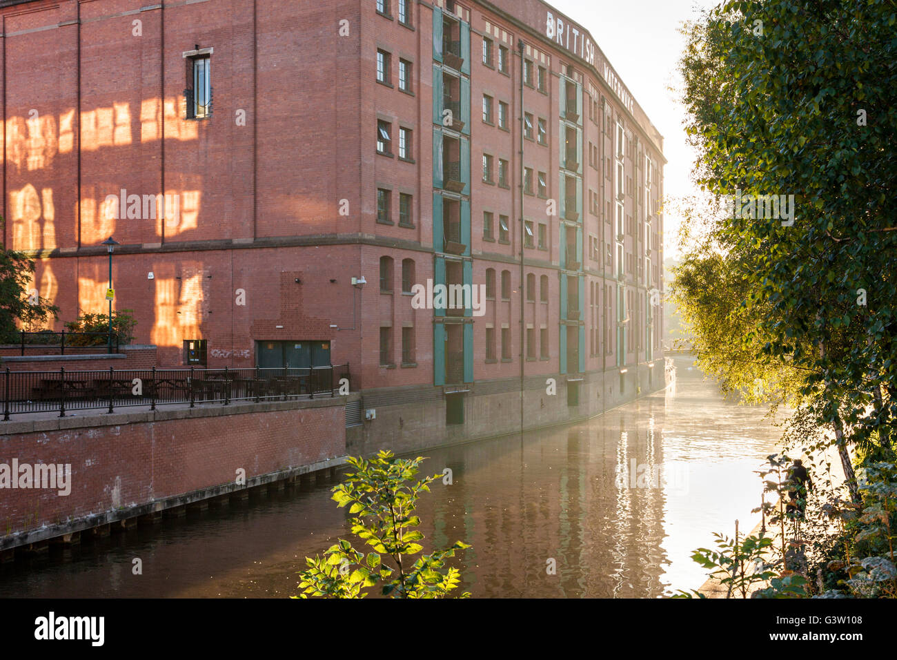 The British Waterways warehouse building next to the Nottingham and Beeston Canal with early morning sunlight and mist, Nottingham, England, UK Stock Photo