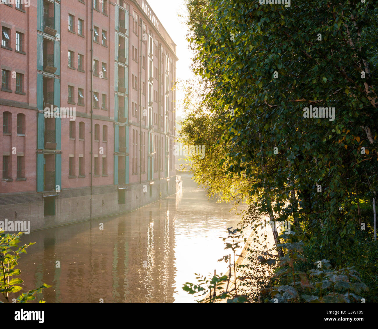 British Waterways warehouse building in early morning sunlight and mist on the Nottingham and Beeston Canal, in the city of Nottingham, England, UK Stock Photo