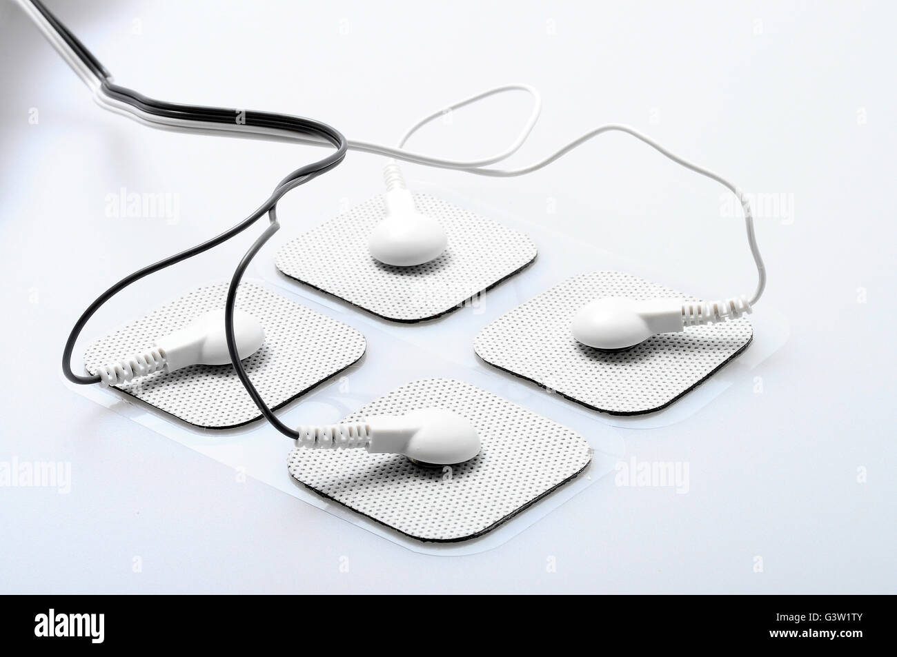 Close up of white electrodes and electrical stimulation device Stock