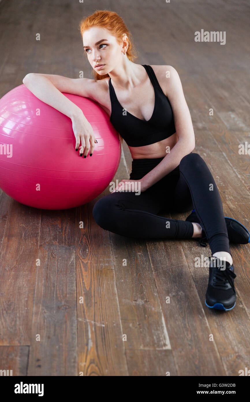 Young fitness woman sitting with fit ball at the gym Stock Photo - Alamy