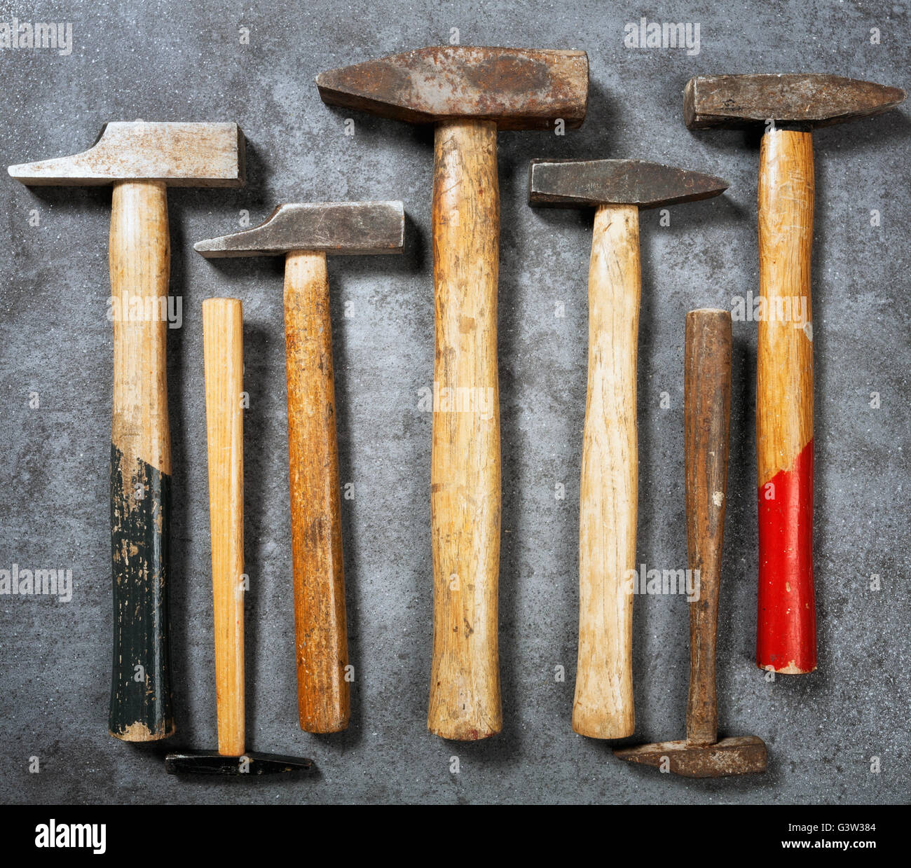 Tool background. Old vintage hammer collection on grunge stone workbench.  Top view, flat lay Stock Photo - Alamy