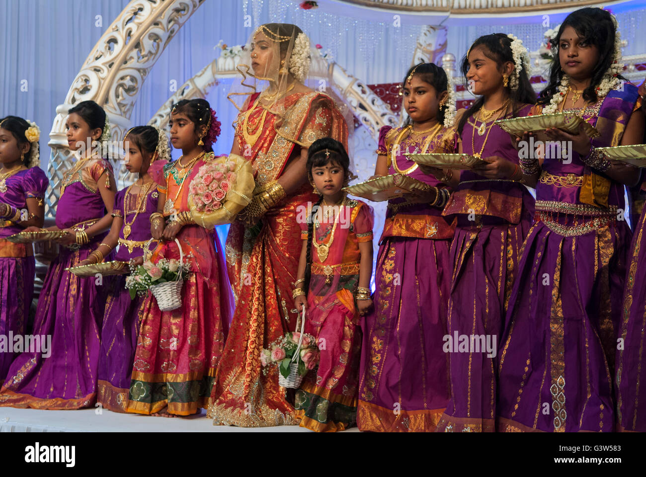 Hindu 16 year old Coming of Age celebration puberty party.  Ritushuddhi,  also called as Ritu Kala Samskara,  Mitcham South London Teenage girl in veil in centre of photograph. HOMER SYKES Stock Photo