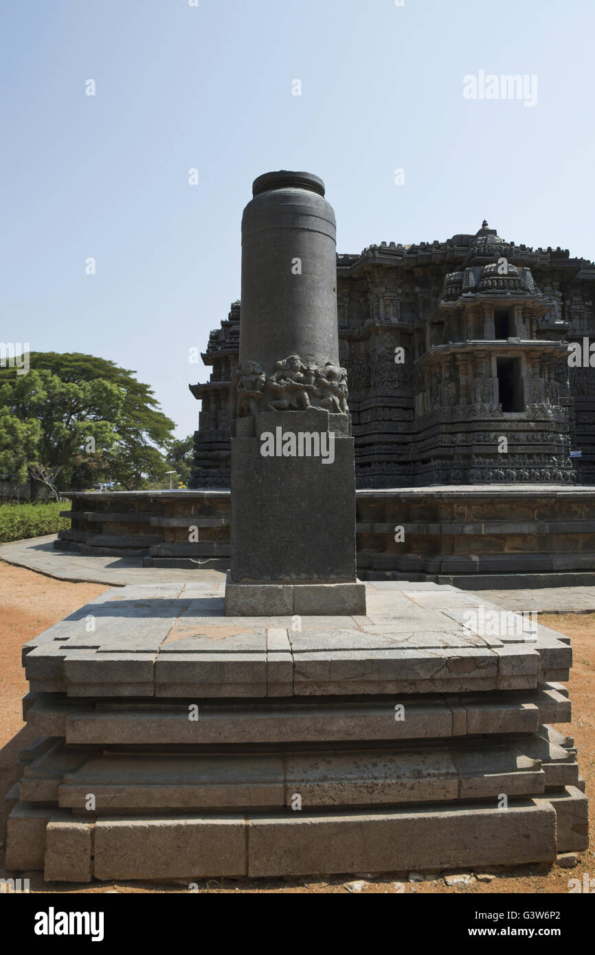 Garuda pillar in front and Hoysaleshwara temple in the background, Halebidu, Karnataka, india. View from South. Stock Photo