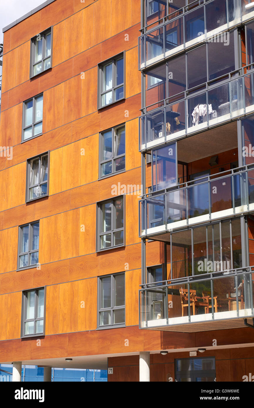 Modern apartment building with wooden facade and enclosed glass ...
