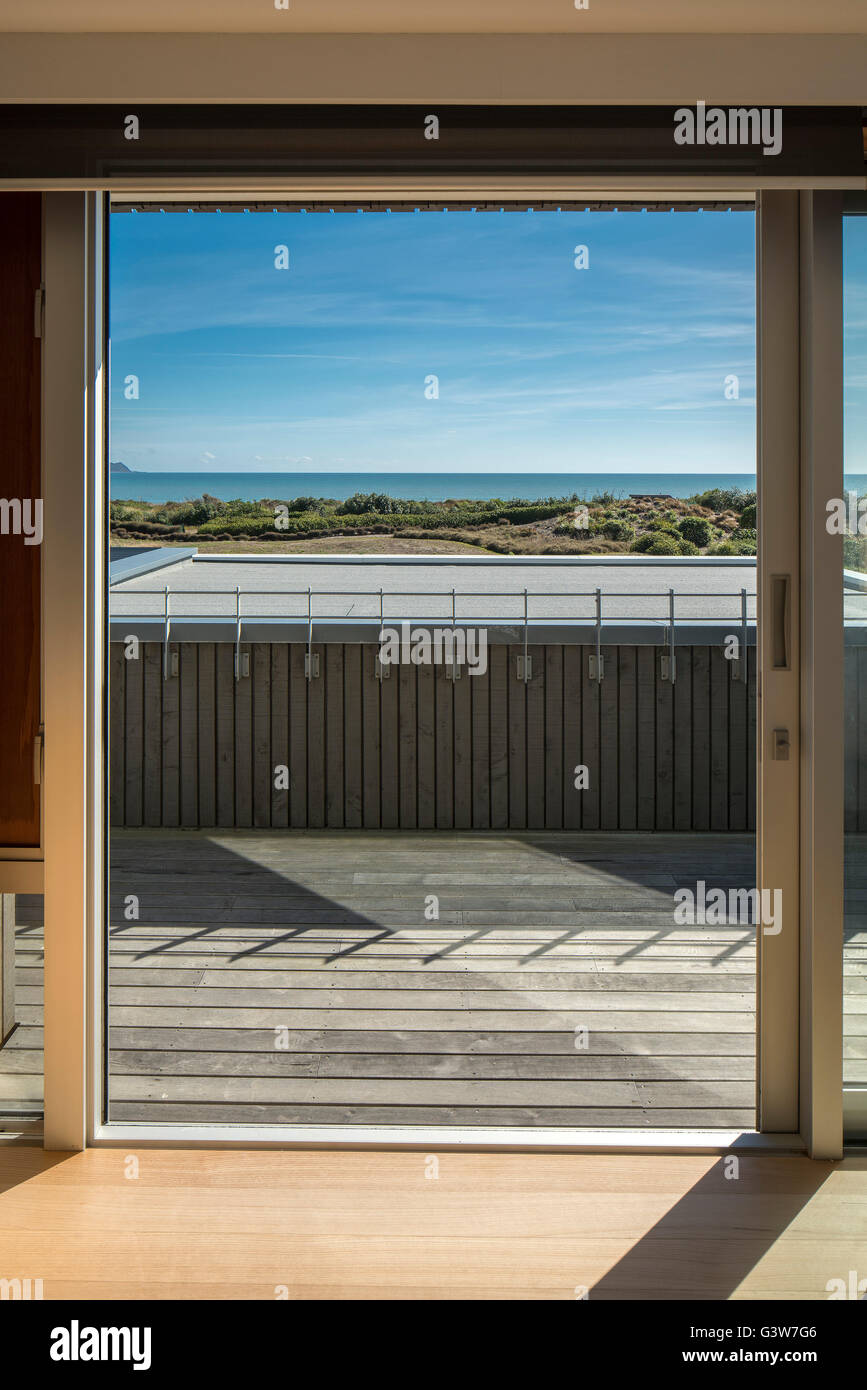 View out of window to sea. Waikanae House, Peka Peka - Kapiti Coast, New Zealand. Architect: Herriot Meluish Architects, 2015. Stock Photo