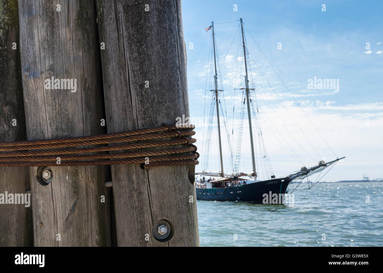 Wooden pillar wound with rope with tour clipper tall ship "Clipper City