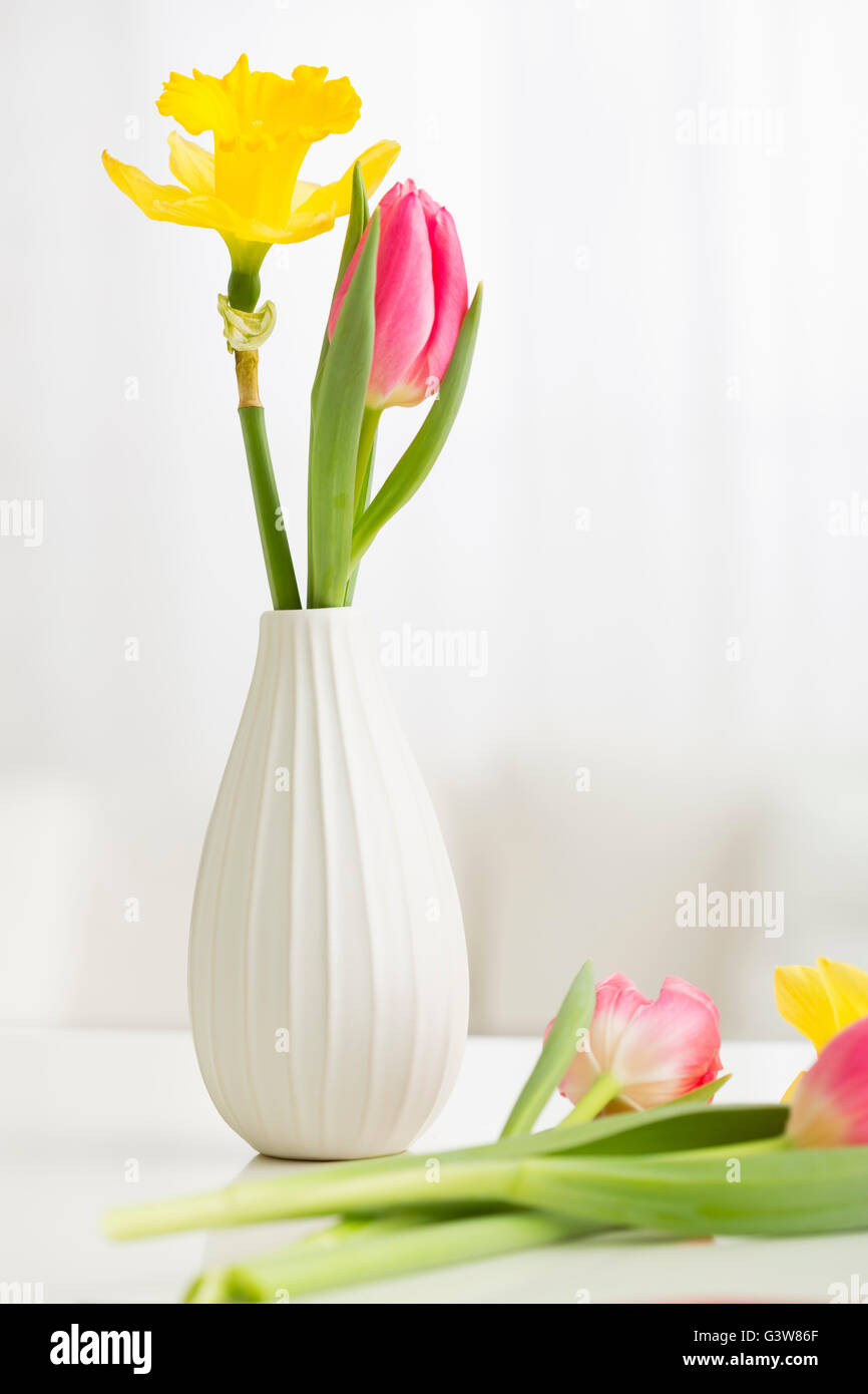 Bouquet of tulips and daffodils in vase Stock Photo