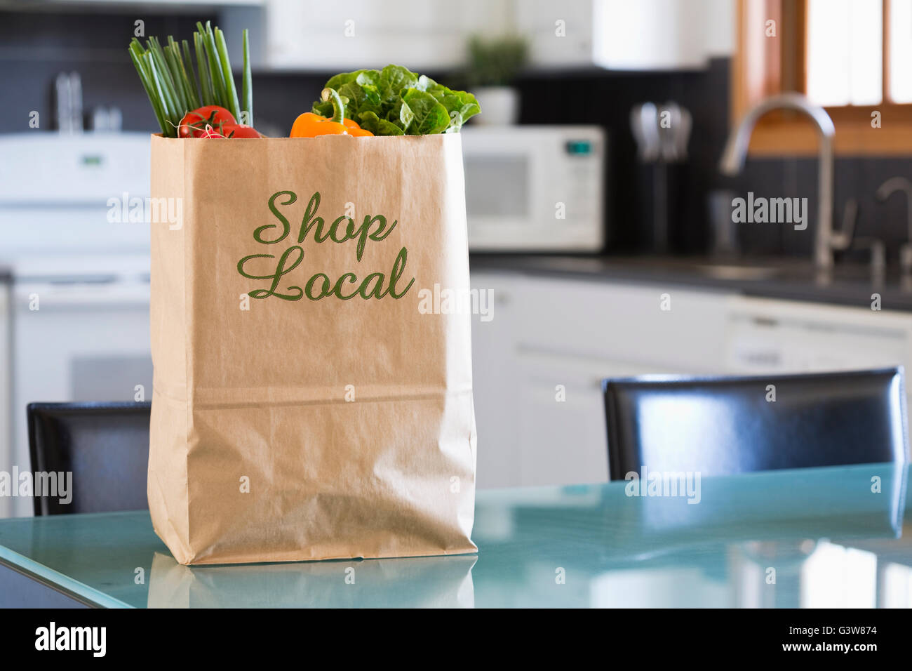 Paper bag with fresh vegetables in kitchen Stock Photo