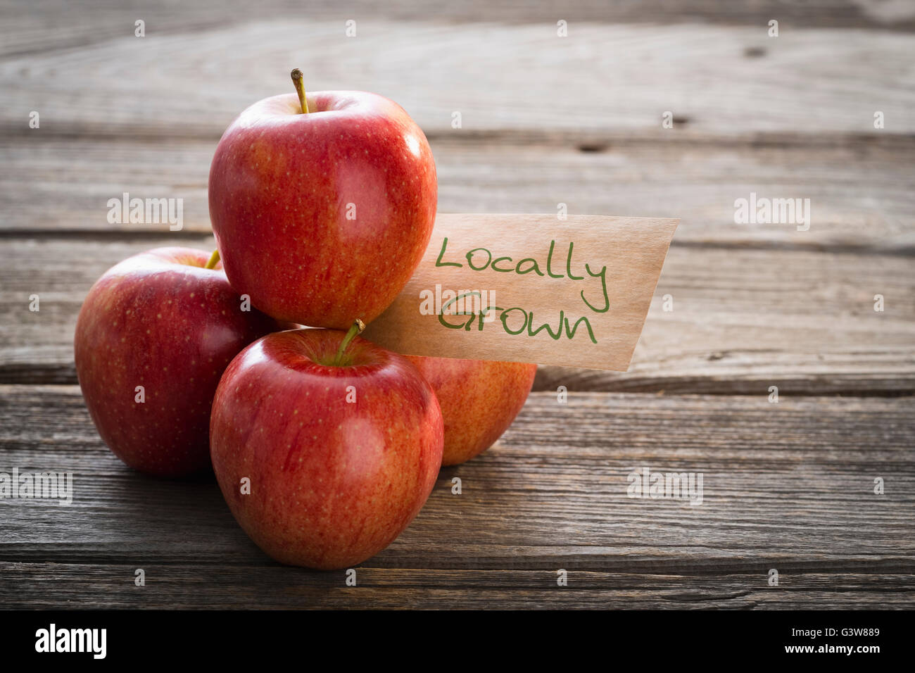 Red apples on wooden market stall Stock Photo