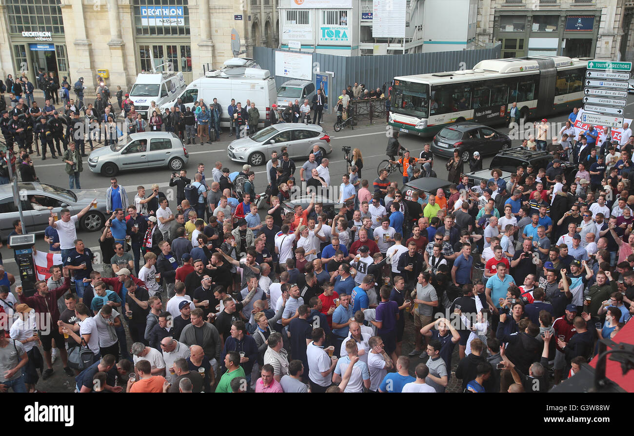 England fans drink outside the train station in Lille city centre, France, as fresh clashes have taken place between England fans and Russian hooligans at Euro 2016. Stock Photo