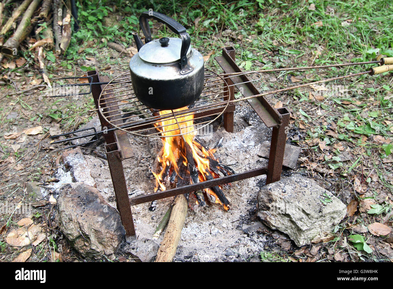 Making tea on the camp fire - teapot on fire Stock Photo