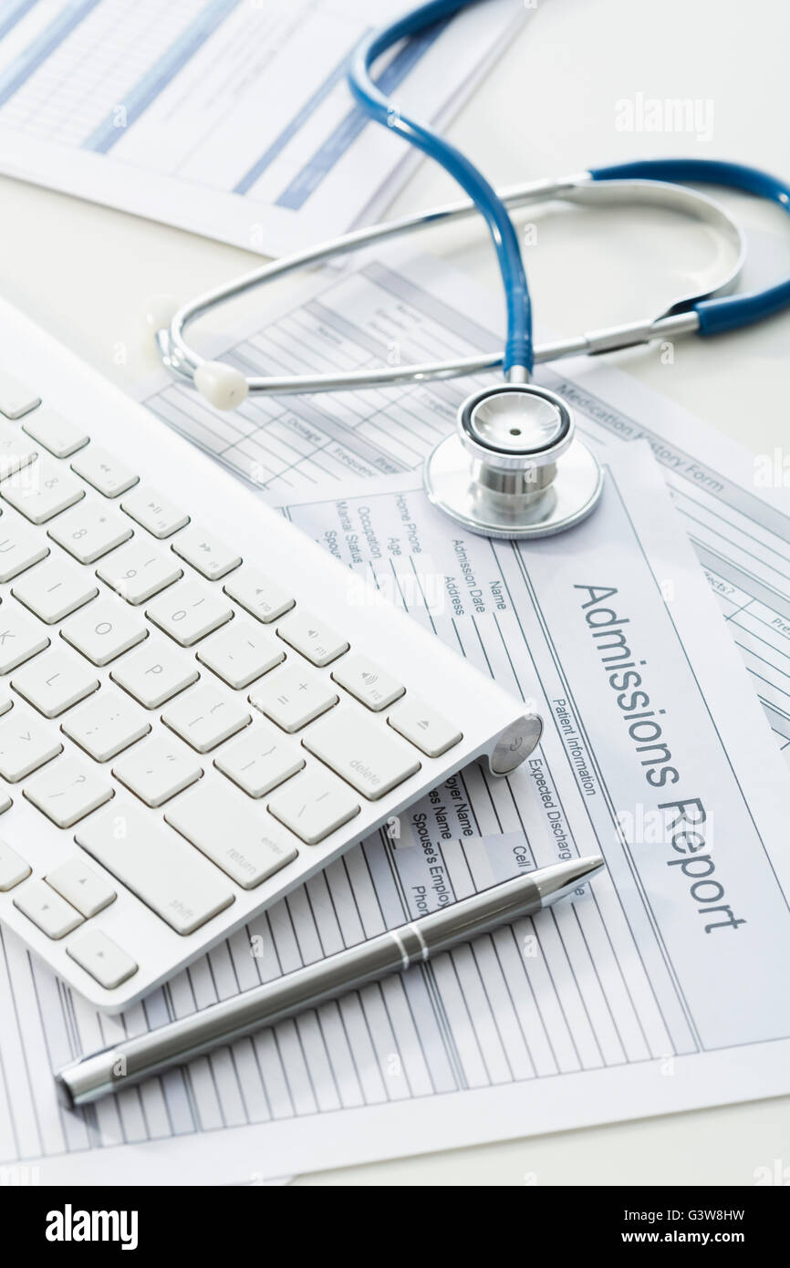 Keyboard, pen and stethoscope on medical document Stock Photo