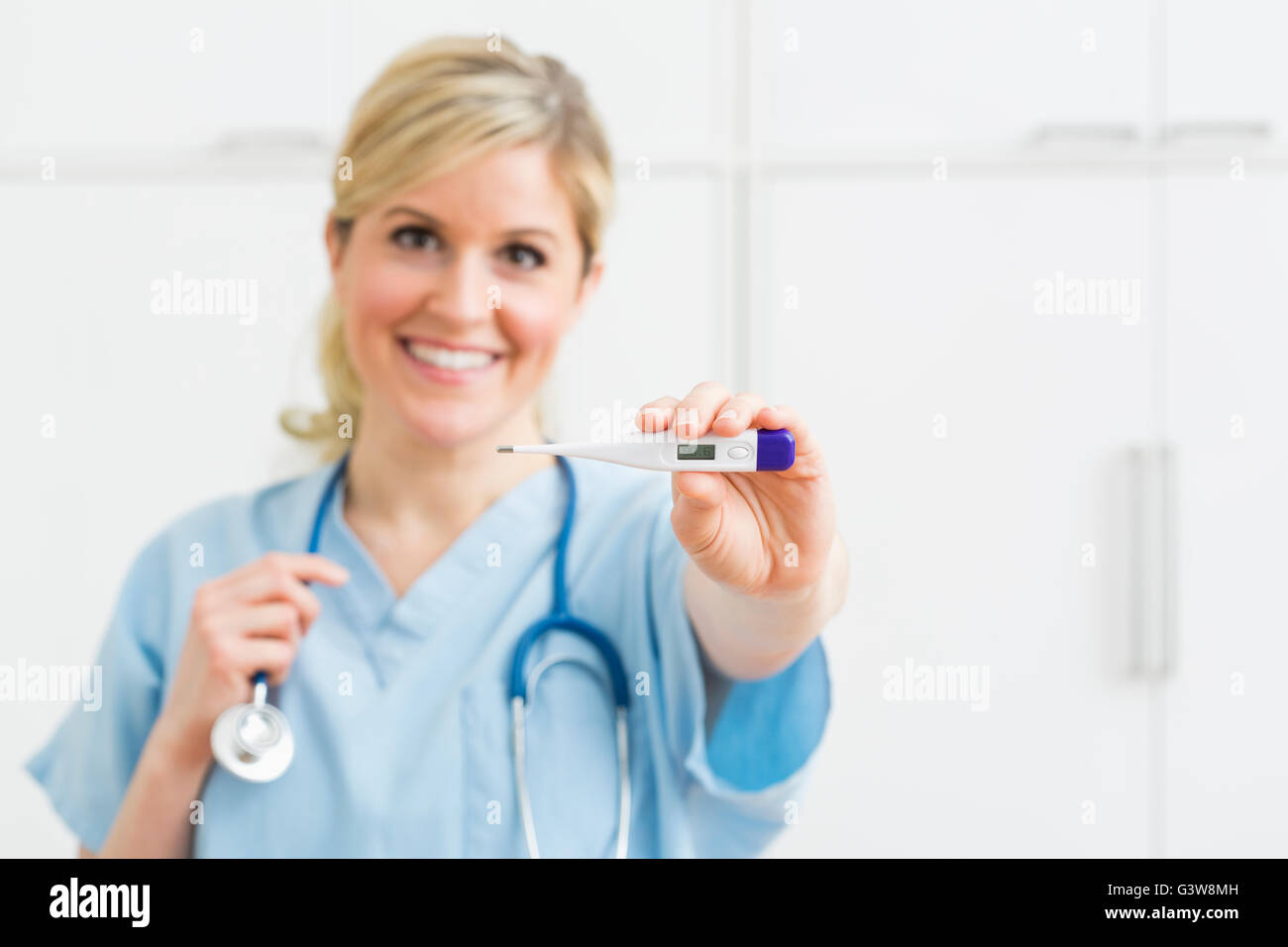 Female nurse holding thermometer Stock Photo