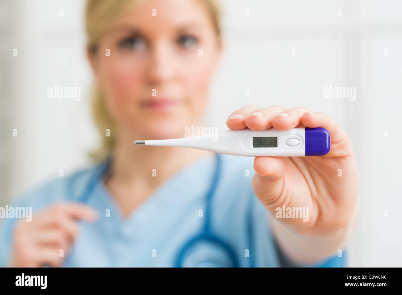 Female nurse holding thermometer Stock Photo