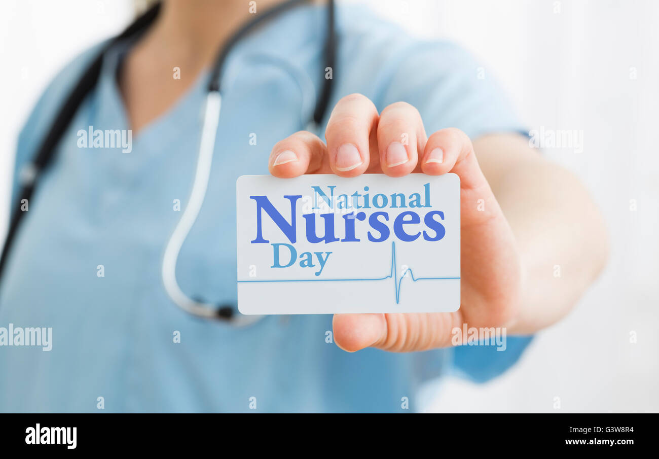 Female nurse holding National Nurses Day card Stock Photo