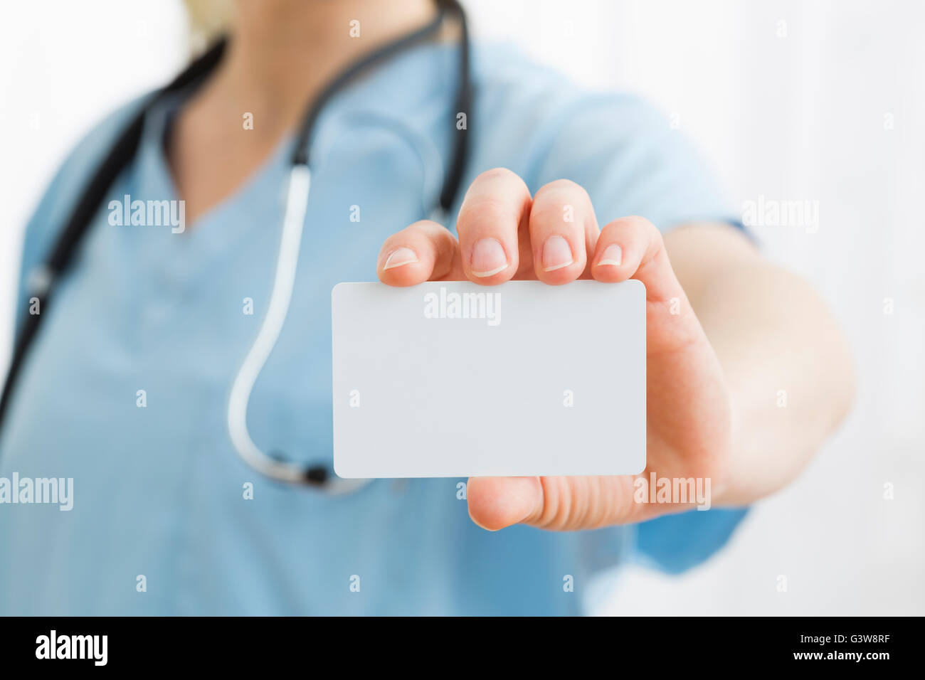 Female nurse holding blank card Stock Photo