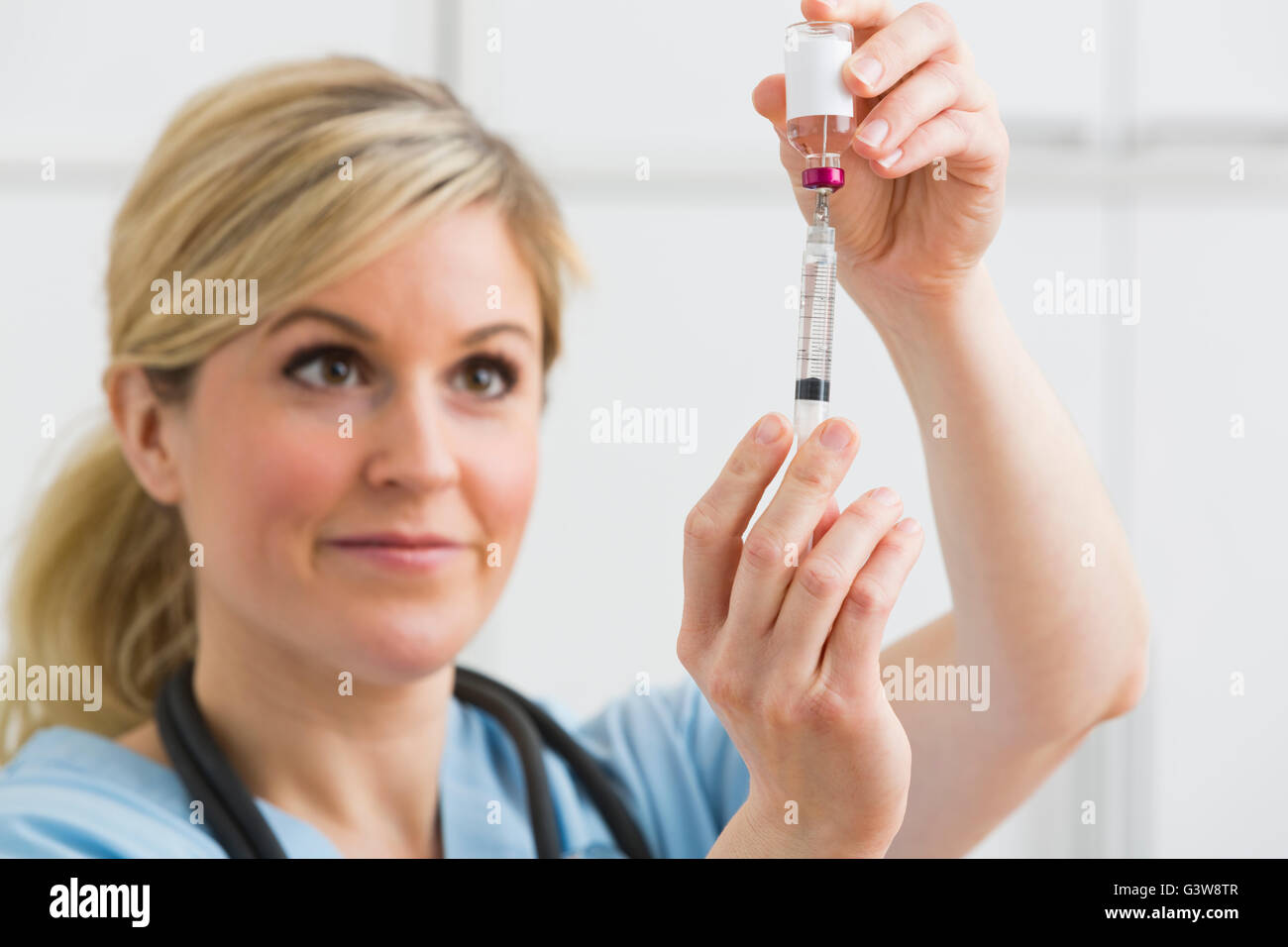 Female nurse holding syringe Stock Photo