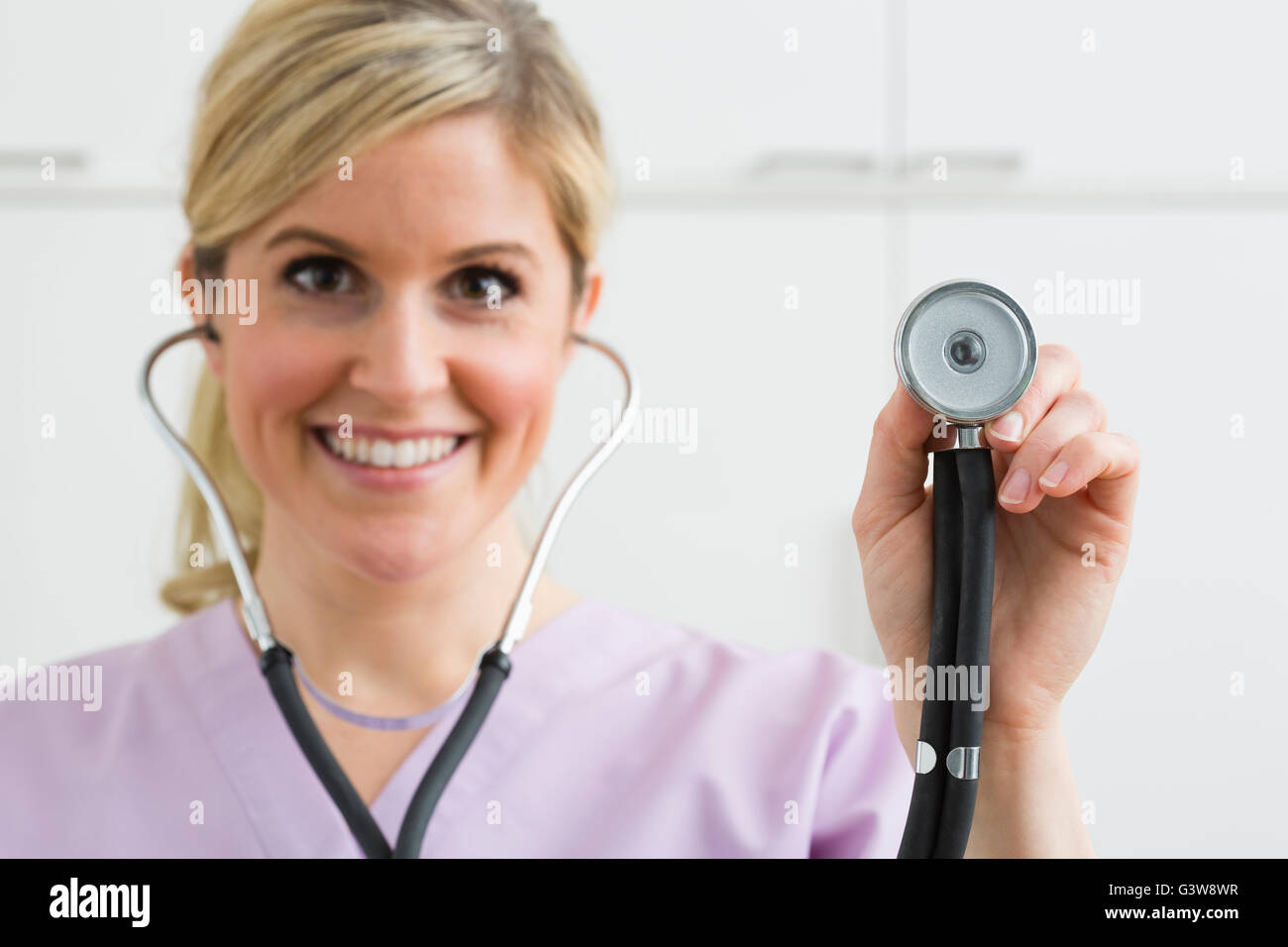 Portrait of female nurse holding stethoscope Stock Photo