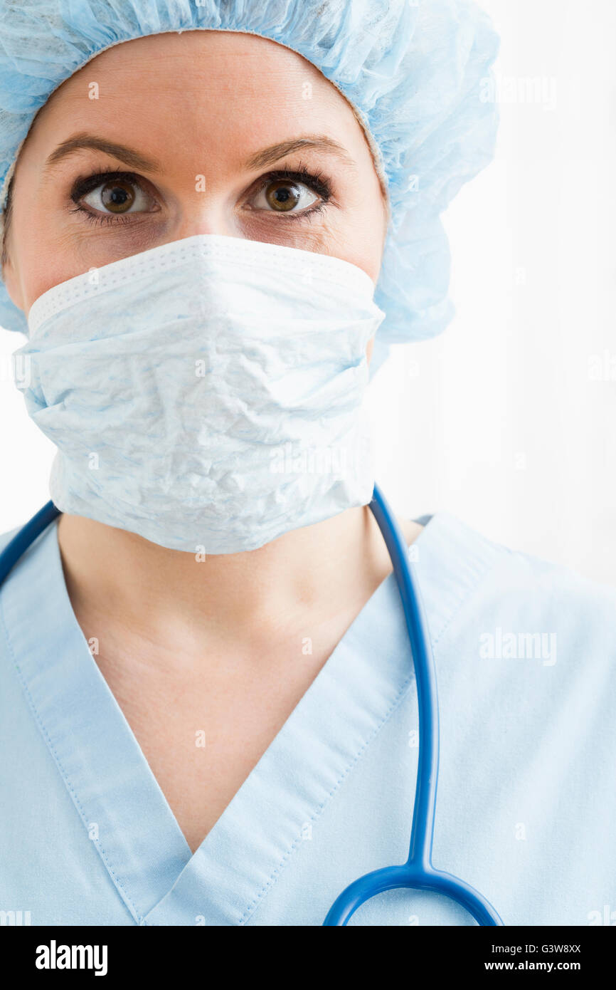 Portrait of female nurse with surgical cap and mask Stock Photo