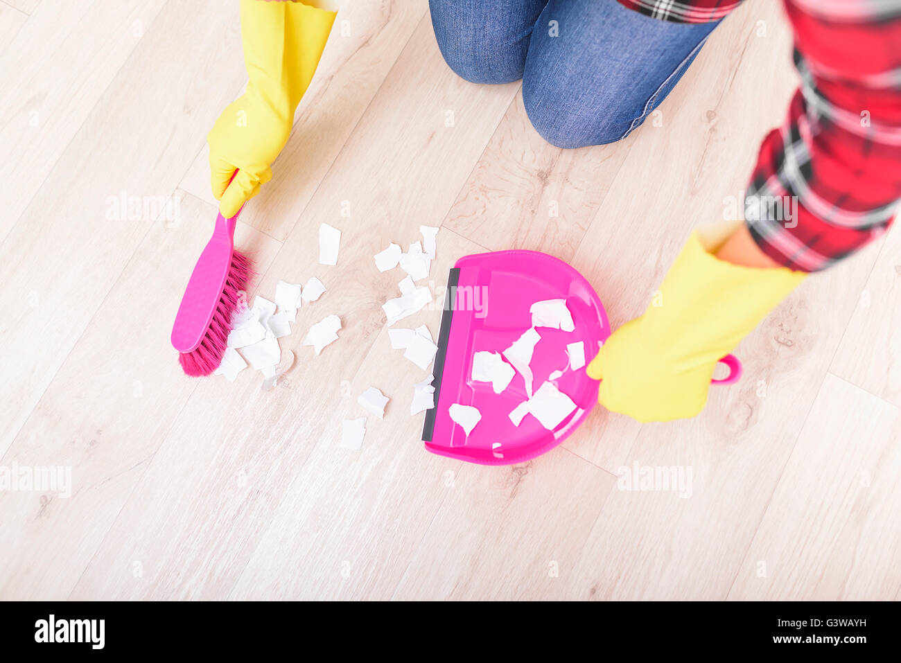 Sweep finely ripped pieces of paper on the floor. Stock Photo