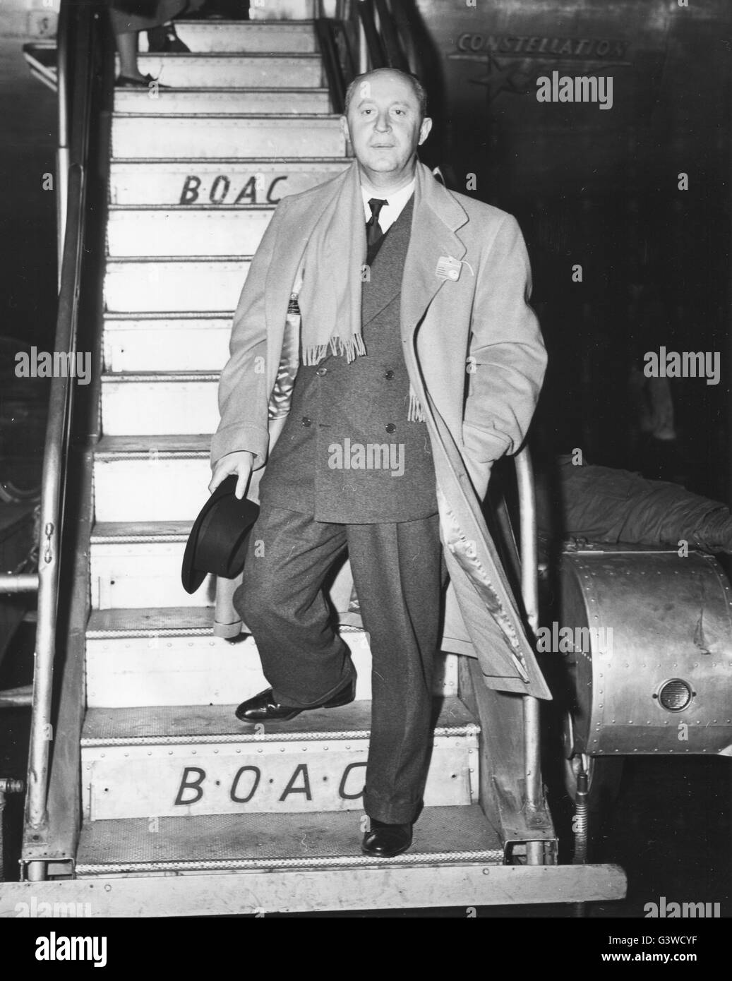 Christian Dior, well known French fashion designer and credited as the originator of the 'New Look' in 1947, arrives from London and Paris on a BOAC Speedbird. Stock Photo
