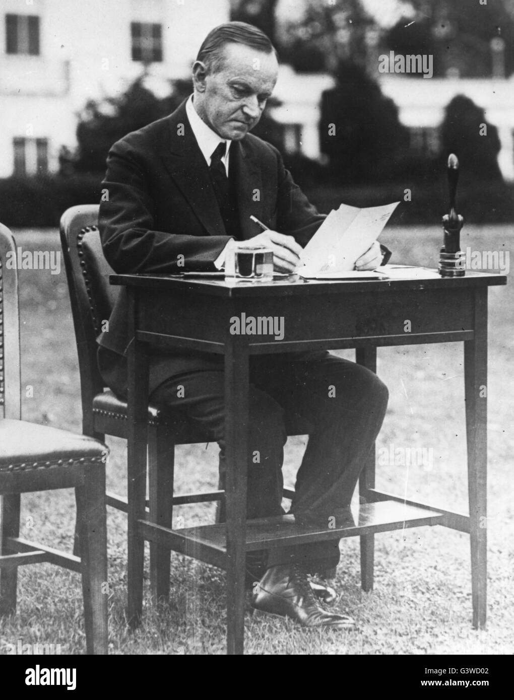 President Calvin Coolidge, on the White House grounds, casting his absentee ballot for the 1924 general election. Stock Photo