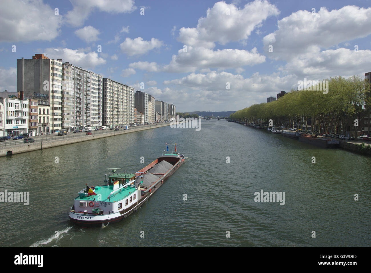 River Meuse in Liège with ship and high-rises, Belgium Stock Photo