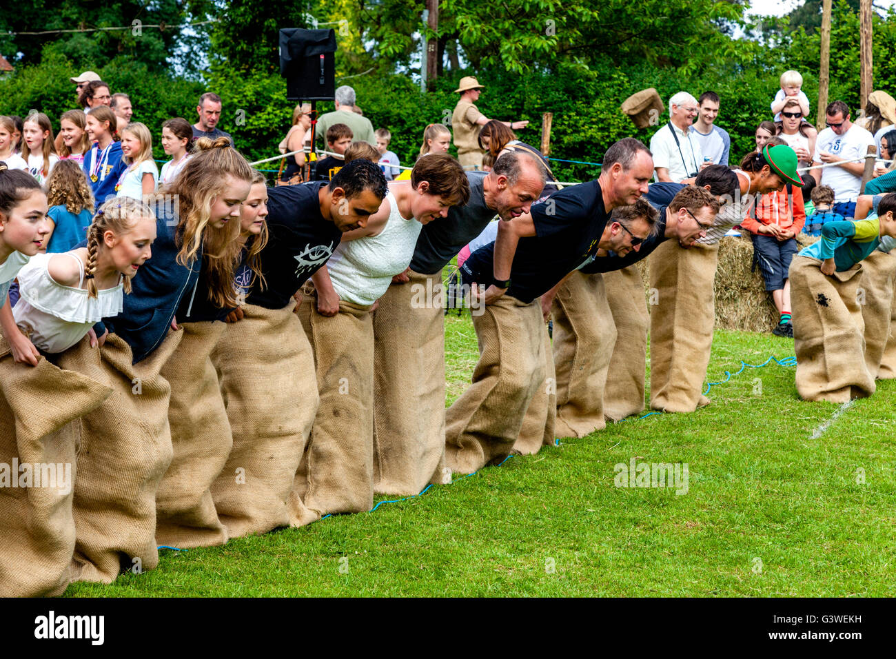 Teenagers and Adults Race In A Traditional Sack Race At The Medieval