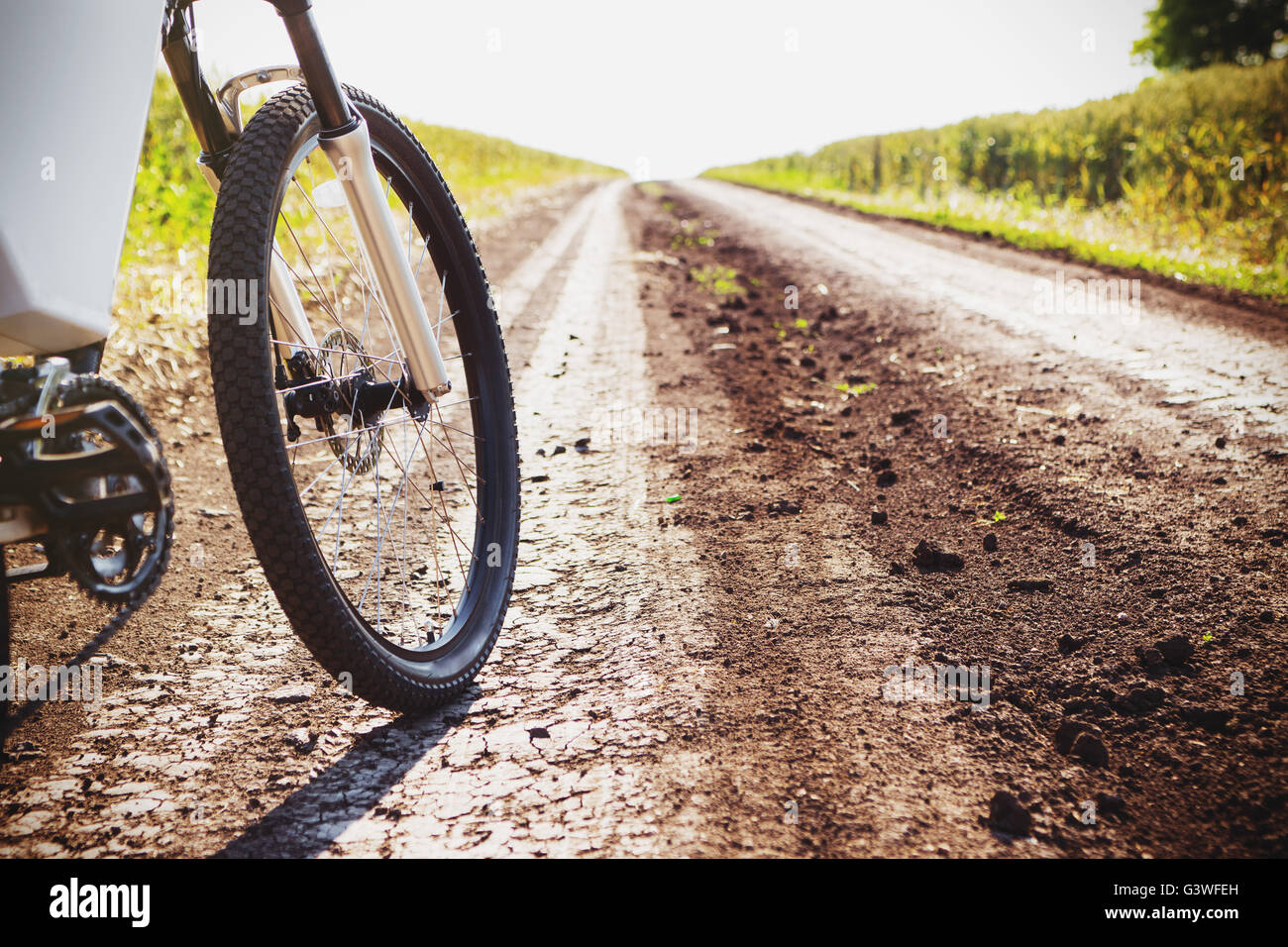 Mountain bicycle at sunny day on the dirt road Stock Photo